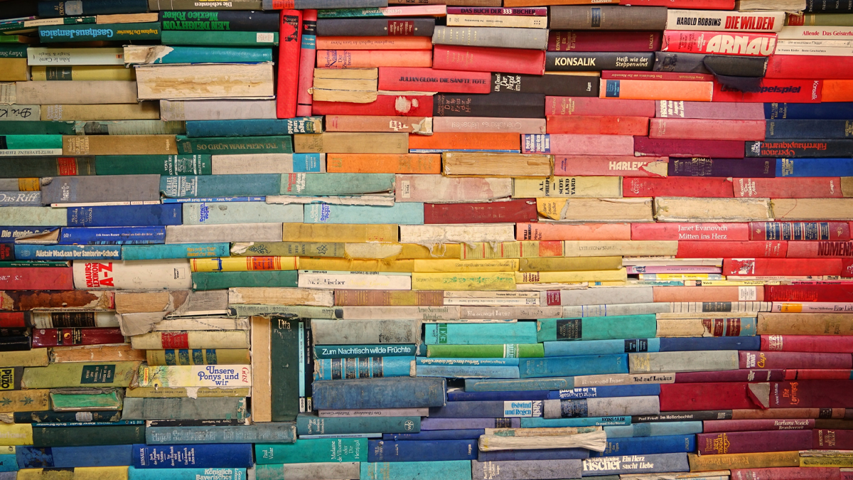 Collection of stacked books organized by color
